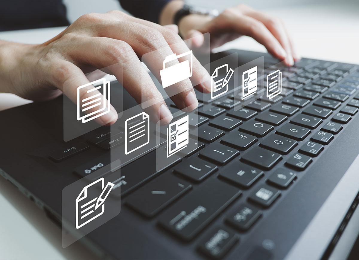 Employee typing on keyboard with icons overlayed on image