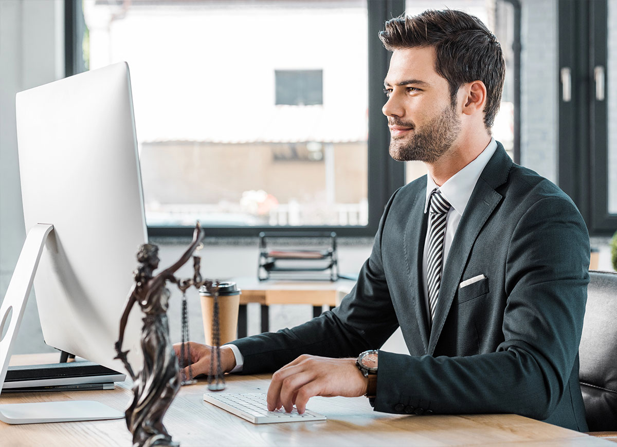 Lawyer sitting at desk working on computer